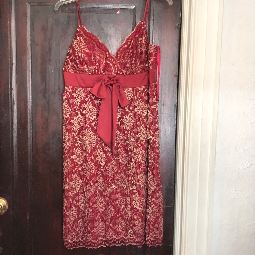Deep red dress with gold colored lace like flowers.